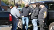The Tennessee Wraith Chasers talking around their trucks.