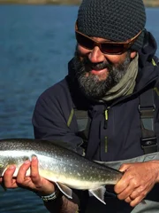 Thad Robison holds an Arctic Char in Greenland.