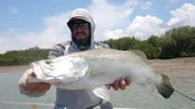 Brian Jill poses with a Barramundi he caught in Australia.