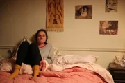 Linda is in her bedroom after getting away from being abused by the driver.