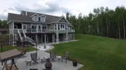 View of the backyard and exterior of the Wasilla Golf House, one of the stops in Luke and Kassandra Higgins' Alaska house search, as seen on Great American Country's Living Alaska