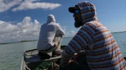 Thad Robison and Brian Jill on a boat in the Bahamas.