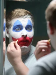 Gacy transforming into Pogo the clown.