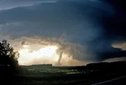 A beautiful but dangerous F4 tornado on June 23, 2002 near Barnard, South Dakota. This tornado was the most violent tornado to ever hit northeast South Dakota. If your bored of beach holidays and looking for something different this summer then you may want to think about a trip to America's mid-west. Storm-chasing husband and wife team Roger and Caryn Hill take British tourists on the hunt of their lives following deadly and destructive tornados. Plowing their way through America's 'Tornado Alley' Roger and Caryn drive groups of up to 18 people at a time in three buses and charge up to £230 a day for a ten day tornado chase. Offering their adrenaline inducing 'Silver Lining Tours', Roger, 53 and Caryn, 50, estimate that they have taken almost 1500 people to observe raging tornado's in the American Mid-West since 2000. Taking their paying guests to within 1/4 of mile of some of the swirling 300 mph vertical wind funnels, the husband and wife team have documented awe inspiring incidents of turning twisters and powerful super-cell storms.