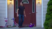 Nancy's coworker looks both ways in front of her house.