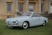 The 1965 VW Karmann Ghia after it is restored by the Car SOS team is posed outside Croome Court in Worcestershire