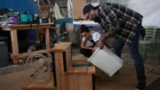 Grace Lee and Antonio Ballatore test water in the outdoor drinking station.
