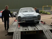 Tim Shaw helps unload Lee's 1965 Karmann Ghia when it arrives back at the Car SOS workshop in the midlands.