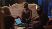 Mariana van Zeller (L) during interview with masked individuals. (Credit: National Geographic)