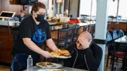 Chef Robert Irvine orders dishes from the old menu at The Anchor before remodeling the restaurant, as seen on Restaurant: Impossible, season 18.