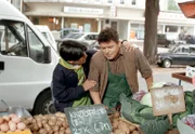 Timo (Marco Soumikh) stützt Markt-Henry (Thor W. Müller, rechts), der einen Schwächeanfall hat.