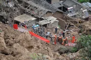 Rescuers search for survivors at the scene of the mudslide.