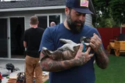 Antonio Ballatore holds sleeping puppy, Frankie.