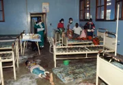 The body of an Ebola virus victim lies on the floor of a ward in Kikwit General Hospital among stripped beds and filthy mattresses.