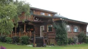 Exterior, cabin style house with many wood burls as d?cor, shot of front door with antlers on the roof, one of the stops in the Bushatz house search, at Scott Road House, Fairbanks, Alaska, as seen on Great American Country's Living Alaska