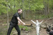 Eddie Sexton uses an ax to cut a Jesus statue.