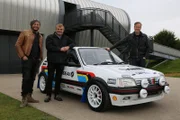 Warwickshire, United Kingdom - Car SOS presenters Tim Shaw and Fuzz Townshend stand with owner Jeremy in front of his newly restored Peugeot 205.
