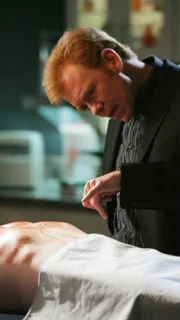 Horatio (David Caruso) schaut  sich Bob Keatons Leiche genauer an und entdeckt einen eigenartigen Abdruck auf dem Brustkorb.