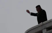 Kim Jong-Un waves during a military parade in Pyongyang to celebrate the 105th anniversary of the birth of his grandfather, North Korea's first leader, Kim Il-Sung.