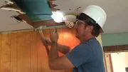 Chip begins construction to raise the kitchen ceiling on demo day, as seen on Fixer Upper.