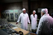 Volodimir Usatenko, Wigald Boning and Dr. Sebastian Pflugbeil stand inside the control room of reactor 4 of the Tschernobyl Nuclear Power Plant while on set during the shooting for the new local production 'Wigald & Fritz - Die Geschichtsjaeger' by the German TV channel HISTORY in Tschernobyl, Ukraine.