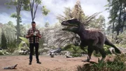 Dr. Dean Lomax stehen neben einem Velociraptor.