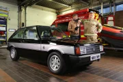 Tim and Fuzz pose with the finished car at the fire station.