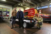 Tim, Fuzz and Jim pose with the finished car at the fire station