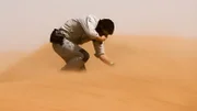 Host Bear Grylls on location in the Sahara desert battling against the wind.