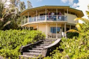 As seen on HGTV's Beach Hunters, homebuyers Sarah and Preston take in the views from the Kaloli Point House with realtor Christine Heidema.