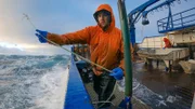 Northwestern deckhand Clark by the rail tossing hook