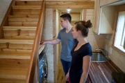 Mark and Angela Eaves look through the storage space Bo was able to fit under the stairs, as seen on Tiny House Big Living.