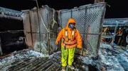 Wizard deckhand Gary standing by ice covered pots on deck