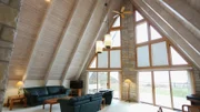The great room in the Manitou Trail House has floor-to-ceiling windows to make the most of the Lake Michigan views, as seen on HGTV's Beach Hunters.
