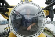 Josh Gates sitzt in dem U-Boot PC1201 am Ufer des Michigansees.