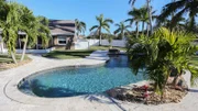 The large backyard and pool at the Bayshore House in Cocoa Beach, Florida, as seen on HGTV's Beach Hunters.