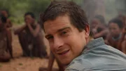 Portrait of Bear Grylls in front of San Bushmen in Namibia.