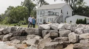 Before heading inside to tour the Rocky Coast House, homebuyers Prashant and Marci take a look at the view from the shore, as seen on HGTV's Beach Hunters.