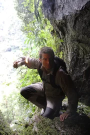 Borneo. Bear Grylls enters a cave.