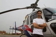 Captain Lorenz Nufer leans on a helicopter.