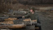 Charlie stacks logs.