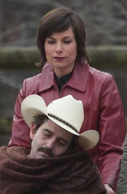 Elisa McNabney and Sarah Dutra push an unconscious Larry McNabney in a wheelchair.