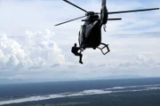 Bear Grylls hanging out of a helicopter.