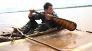 Close up of Bear Grylls in zebra skin canoe.