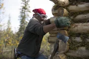 Heimo working on his wood cabin.