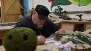 Jason takes some notes on an artificial plants he found that he may use for a build.