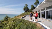 Real estate agent Ronda Busscher shows off the 75-feet of waterfront at the Cali Beach House to homebuyers Darren and Cindy, as seen on HGTV's Beach Hunters.