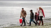 As seen on HGTV's Beach Hunters, homebuyers Kevin and Silvina, along with their two kids, hunt for clams along the beach on Washington's Whidbey Island.