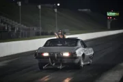 Ronnie Pace is guided back to the starting line after his burnout.