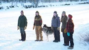 Lewis' Family and dogs venture out to retrieve beaver trapping from frozen river.